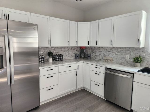 8457 S Main St, Le Ray, NY 13637 - kitchen with appliances with stainless steel finishes, tasteful backsplash, and light stone counters