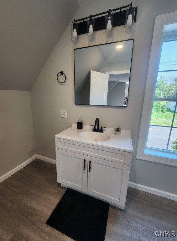 8457 S Main St, Le Ray, NY 13637 - bathroom with vanity, wood finished floors, and vaulted ceiling