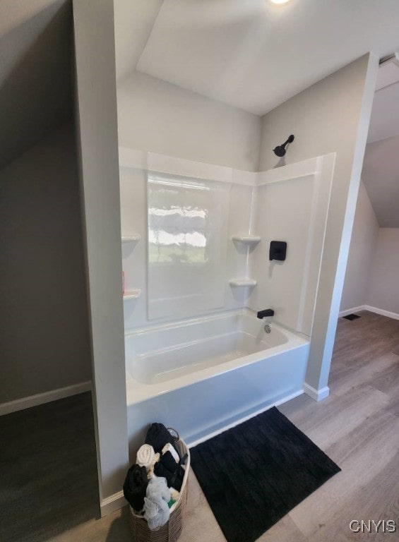 8457 S Main St, Le Ray, NY 13637 - bathroom with shower / washtub combination, wood finished floors, and lofted ceiling