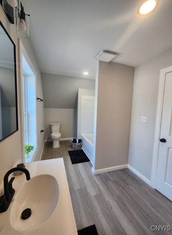 8457 S Main St, Le Ray, NY 13637 - full bath featuring wood finished floors, a bathtub, vanity, and recessed lighting