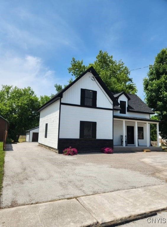 8457 S Main St, Le Ray, NY 13637 - view of front of house with an outdoor structure, a porch, and a garage