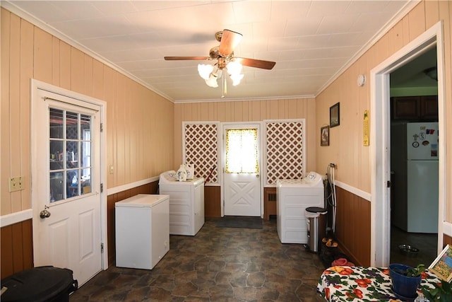 158 Dingman Hill Rd, Bainbridge, NY 13733 - laundry area with dark stone finish flooring, ornamental molding, wood walls, washing machine and dryer, and ceiling fan