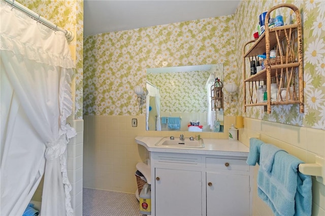 4482 Cory Corners Rd, Marion, NY 14505 - bathroom with wallpapered walls, wainscoting, vanity, and tile walls