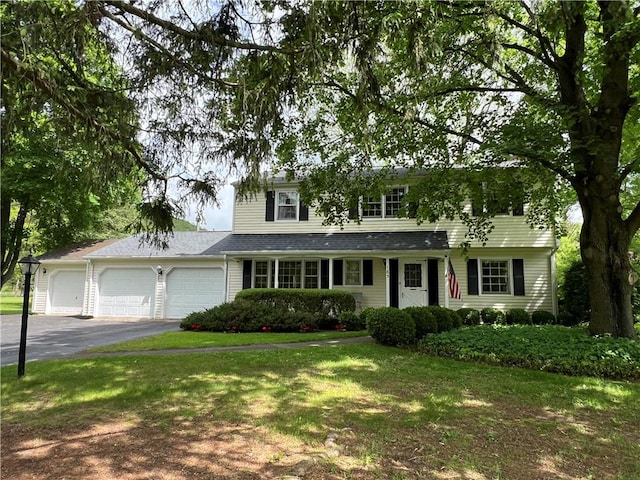 183 Davenport Rd, Big Flats, NY 14814 - traditional home with an attached garage, driveway, and a front lawn