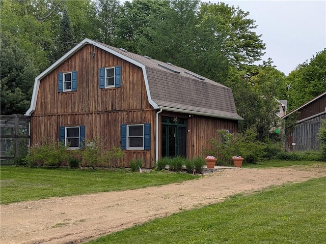 73 Derosia Rd, Lafayette, PA 16738 - view of home's exterior with a gambrel roof, a shingled roof, a lawn, and a barn