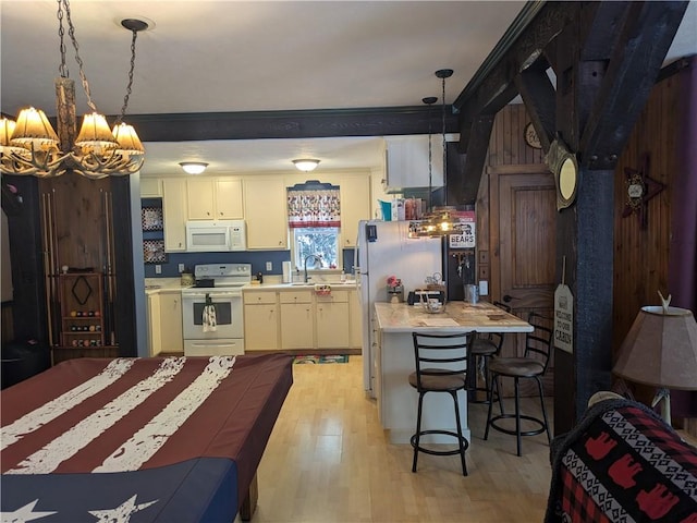 73 Derosia Rd, Lafayette, PA 16738 - kitchen with white appliances, light countertops, a chandelier, light wood-type flooring, and a sink
