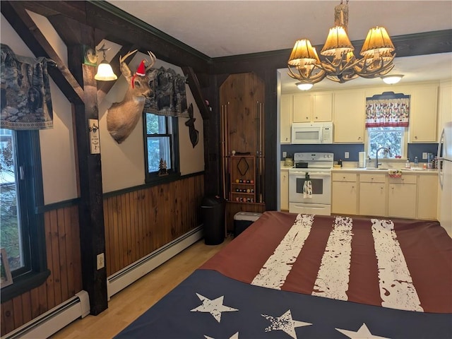 73 Derosia Rd, Lafayette, PA 16738 - kitchen with white appliances, baseboard heating, a chandelier, light countertops, and wainscoting