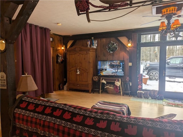 73 Derosia Rd, Lafayette, PA 16738 - living area featuring wood finished floors, wooden walls, and a chandelier