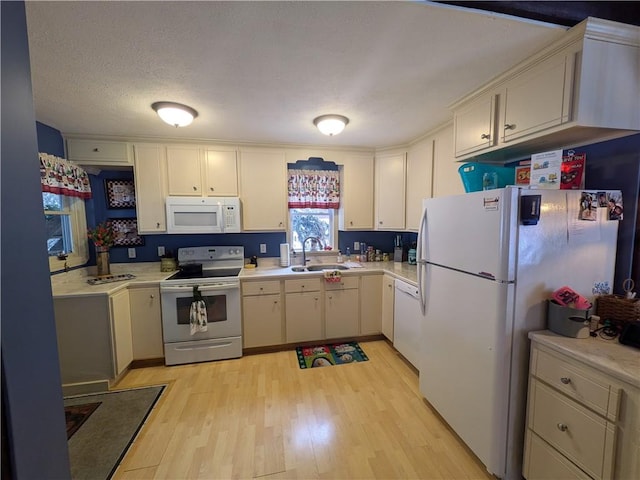 73 Derosia Rd, Lafayette, PA 16738 - kitchen with white appliances, a sink, light wood-type flooring, and light countertops