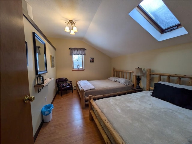 73 Derosia Rd, Lafayette, PA 16738 - bedroom featuring vaulted ceiling, wood finished floors, a skylight, and baseboards
