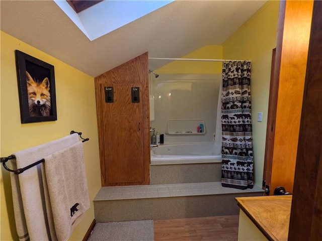 73 Derosia Rd, Lafayette, PA 16738 - bathroom featuring vaulted ceiling, shower / bath combination with curtain, wood finished floors, a skylight, and vanity