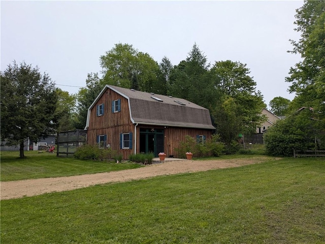 73 Derosia Rd, Lafayette, PA 16738 - view of front of home featuring a gambrel roof, a front yard, a shingled roof, driveway, and an outdoor structure