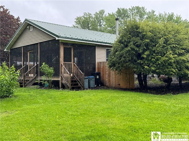 131 Goose Creek Rd, Busti, NY 14710 - rear view of house with a sunroom, a yard, stairway, and metal roof