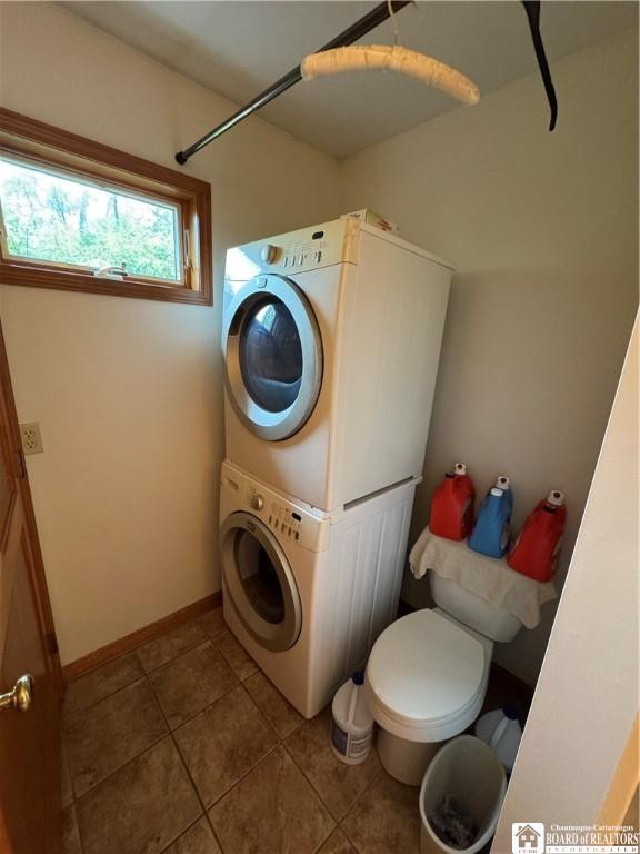 131 Goose Creek Rd, Busti, NY 14710 - laundry area with stacked washer / dryer, tile patterned flooring, and baseboards