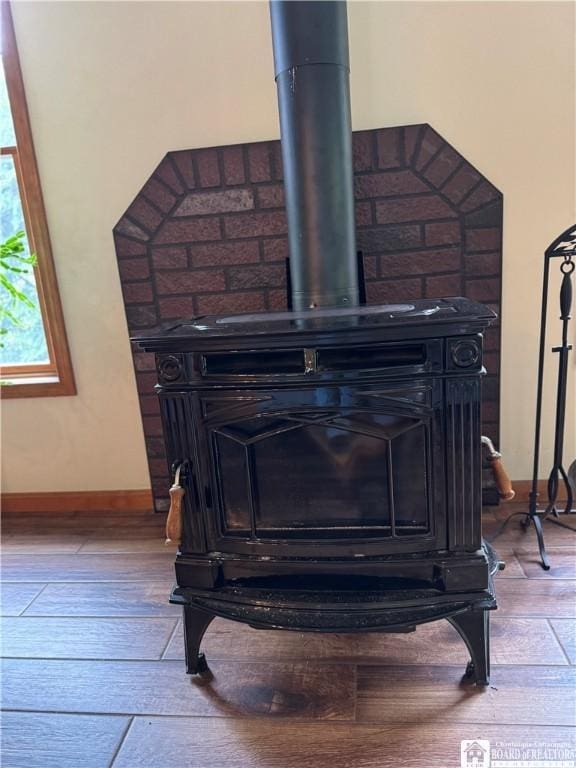 131 Goose Creek Rd, Busti, NY 14710 - detailed view of wood finished floors, baseboards, and a wood stove