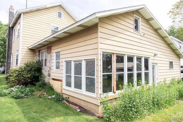 204 E Ellis St, Dewitt, NY 13057 - view of side of home with a chimney and a yard