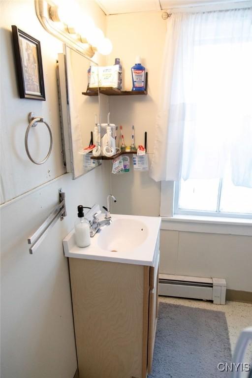 204 E Ellis St, Dewitt, NY 13057 - bathroom featuring baseboard heating and vanity