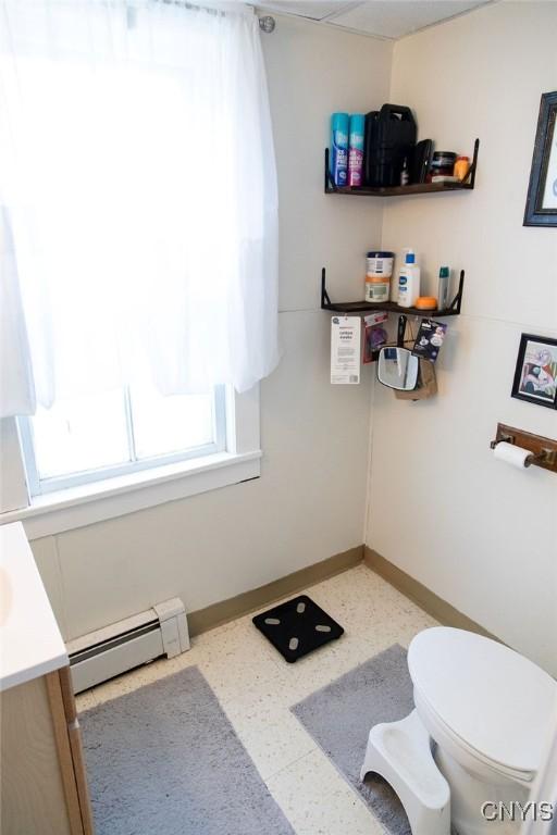 204 E Ellis St, Dewitt, NY 13057 - bathroom featuring a baseboard heating unit, vanity, toilet, and baseboards