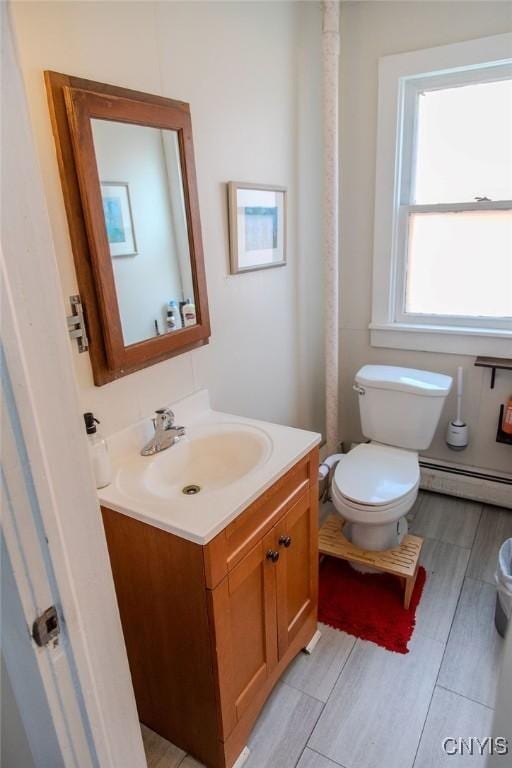 204 E Ellis St, Dewitt, NY 13057 - bathroom featuring toilet, baseboard heating, and vanity