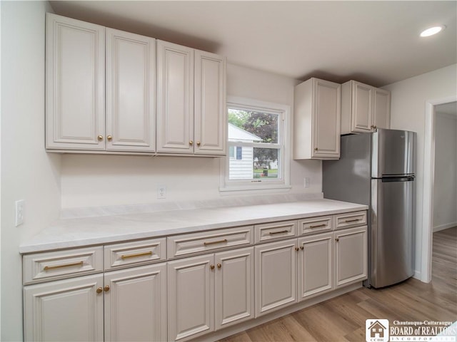413 Chautauqua Ave, Jamestown, NY 14701 - kitchen with freestanding refrigerator, light wood finished floors, light countertops, recessed lighting, and white cabinetry