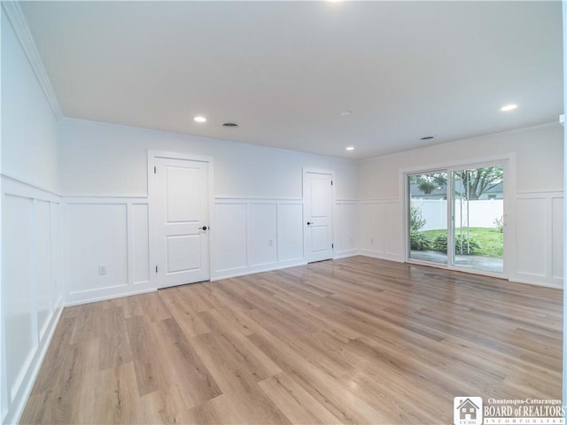 413 Chautauqua Ave, Jamestown, NY 14701 - unfurnished room with a decorative wall, crown molding, wainscoting, and light wood finished floors