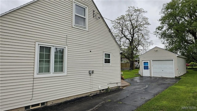 76 Sandra Dr, Cheektowaga, NY 14225 - view of side of property featuring an outbuilding, a detached garage, a lawn, and driveway