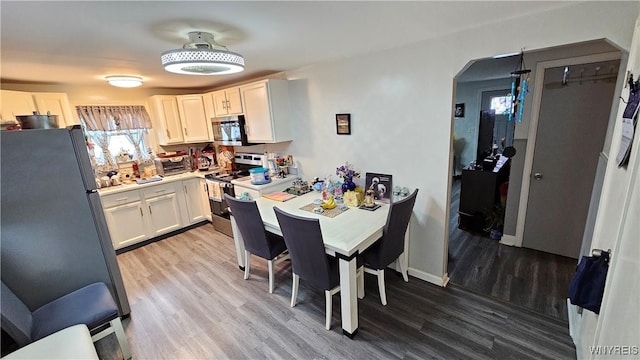 76 Sandra Dr, Cheektowaga, NY 14225 - dining room with light wood-style floors and arched walkways