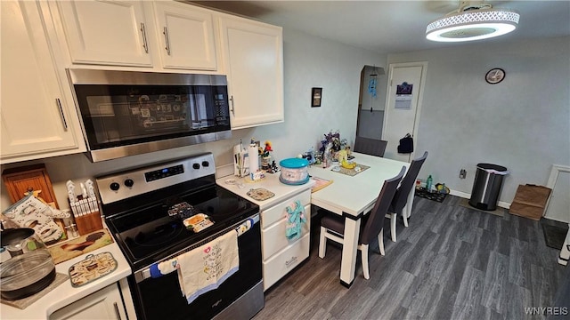 76 Sandra Dr, Cheektowaga, NY 14225 - kitchen with appliances with stainless steel finishes, white cabinetry, light countertops, and dark wood-type flooring