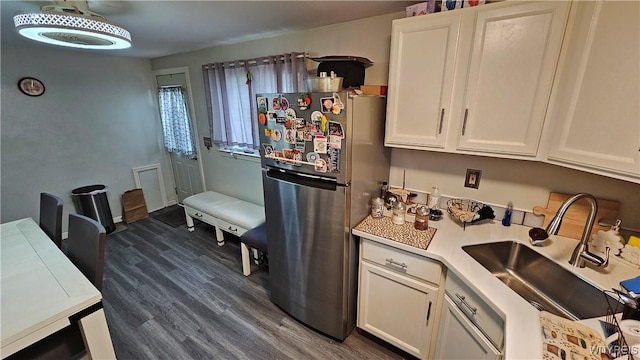 76 Sandra Dr, Cheektowaga, NY 14225 - kitchen with freestanding refrigerator, a sink, dark wood-style floors, light countertops, and white cabinetry