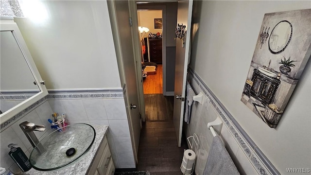 76 Sandra Dr, Cheektowaga, NY 14225 - bathroom with vanity, wainscoting, and tile walls