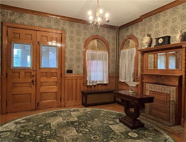 110 Edgar James St, Kane Boro, PA 16735 - foyer entrance with a chandelier, wallpapered walls, crown molding, and a wainscoted wall