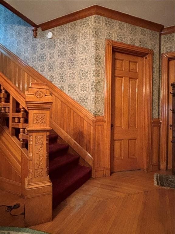 110 Edgar James St, Kane Boro, PA 16735 - stairs featuring wallpapered walls, a wainscoted wall, and crown molding
