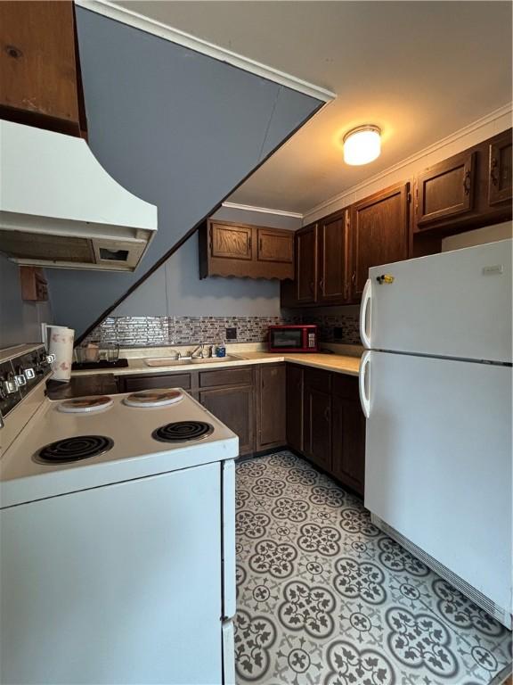 110 Edgar James St, Kane Boro, PA 16735 - kitchen featuring white appliances, exhaust hood, a sink, light countertops, and dark brown cabinetry