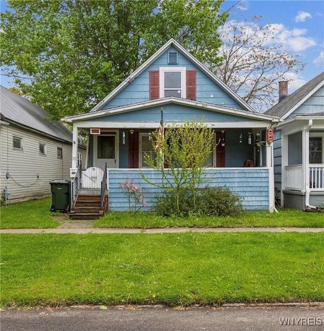 125 7th Ave, North Tonawanda, NY 14120 - bungalow featuring covered porch and a front yard