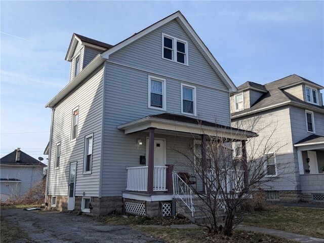 313 Ellicott St, Rochester, NY 14619 - traditional style home featuring covered porch