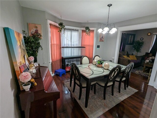 313 Ellicott St, Rochester, NY 14619 - dining area with dark wood-type flooring and a chandelier