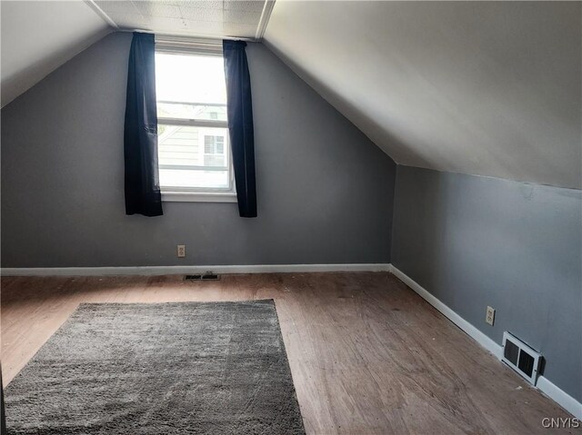 116 Kendall Dr E, Manlius, NY 13057 - additional living space with wood finished floors, lofted ceiling, and baseboards