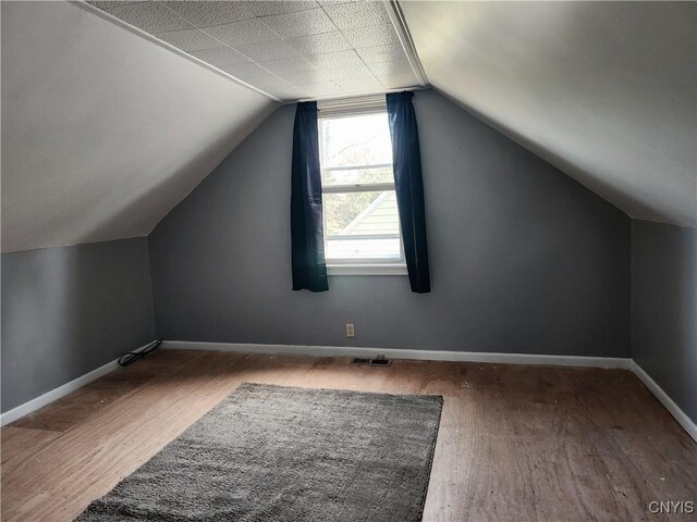 116 Kendall Dr E, Manlius, NY 13057 - additional living space featuring wood finished floors, lofted ceiling, and baseboards