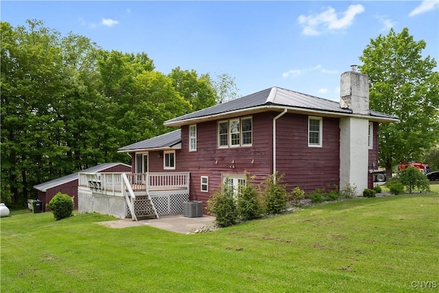 3232 Lyon Rd, Nelson, NY 13035 - back of property with a wooden deck, a chimney, metal roof, and a yard