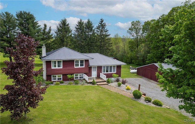 3232 Lyon Rd, Nelson, NY 13035 - split level home with a front lawn, a chimney, metal roof, and gravel driveway