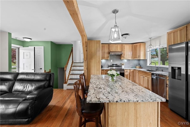 3232 Lyon Rd, Nelson, NY 13035 - kitchen featuring appliances with stainless steel finishes, under cabinet range hood, open floor plan, tasteful backsplash, and a sink