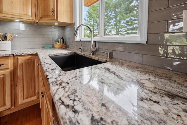 3232 Lyon Rd, Nelson, NY 13035 - kitchen featuring a sink, backsplash, and light stone countertops