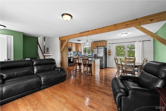 3232 Lyon Rd, Nelson, NY 13035 - living area with stairs, light wood-style flooring, and beamed ceiling