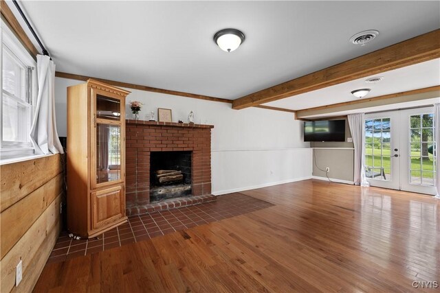 3232 Lyon Rd, Nelson, NY 13035 - unfurnished living room with a fireplace, wood finished floors, beamed ceiling, and french doors
