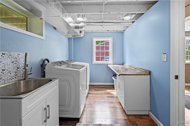 3232 Lyon Rd, Nelson, NY 13035 - laundry room with washer and clothes dryer, wood finished floors, baseboards, and cabinet space