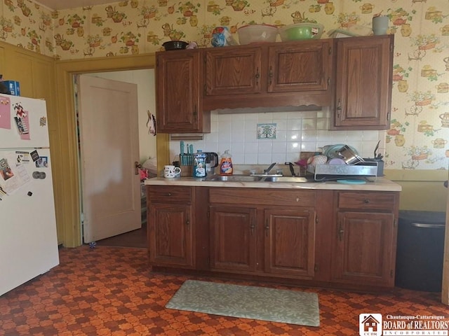 38 Douglas Pl, Jamestown, NY 14701 - kitchen with freestanding refrigerator, wallpapered walls, a sink, light countertops, and tasteful backsplash