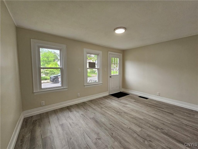 11 Bryant St, Utica, NY 13502 - empty room with wood finished floors and baseboards