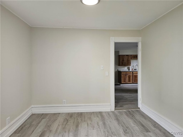 11 Bryant St, Utica, NY 13502 - empty room with light wood-type flooring, baseboards, and ornamental molding