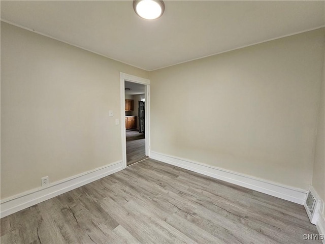 11 Bryant St, Utica, NY 13502 - spare room featuring wood finished floors and baseboards