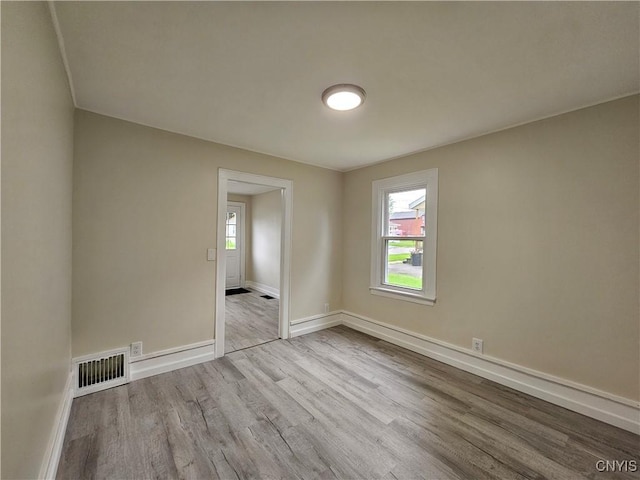 11 Bryant St, Utica, NY 13502 - unfurnished room with wood finished floors and baseboards